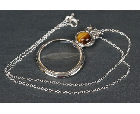 Silver magnifying pendant necklace in the form of an owl with tiger's eye cabochon 