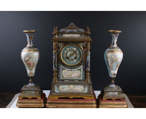 19th century French Gilt Metal and Champlevé Enamel Clock Garniture, the 8 day movement clock set with porcelain panels hand 