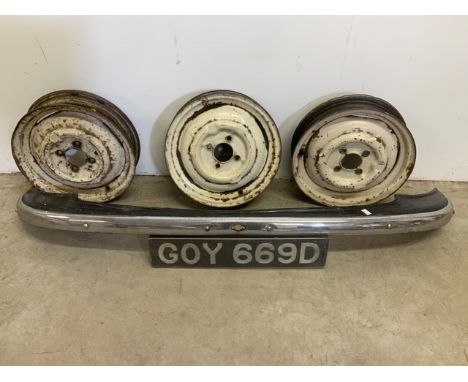 A 1966 Morris bumper with license plate reading GOY 669D Together with three vintage car alloy wheels. Bumper: W:146cm. Wheel