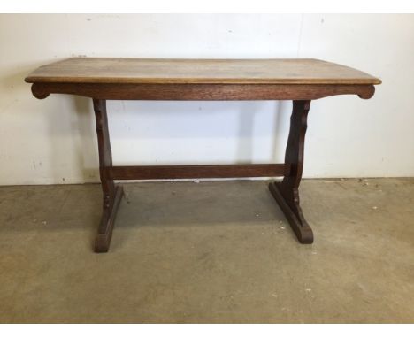 An Ercol style oak table.W:137cm x D:69cm x H:75cm