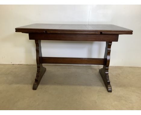 An oak Ercol mid century extending drawer leaf table. In stained wood finish. Extend W:176cm x D:72cm x H:74cmW:114cm x D:72c