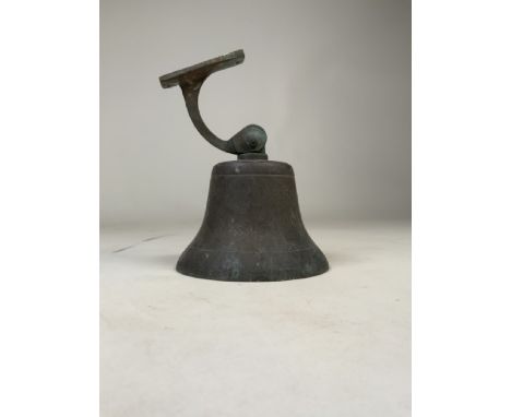 A vintage brass wall hanging ships bell with cast brass bracket. W:15cm x D:15cm x H:20cm
