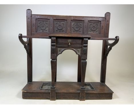 An oak 19th century stick stand with carved back and small drawer to frontW:83.5cm x D:29cm x H:84cm