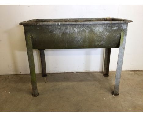 A galvanised metal feeding water trough. W:98cm x D:53cm x H:77cm