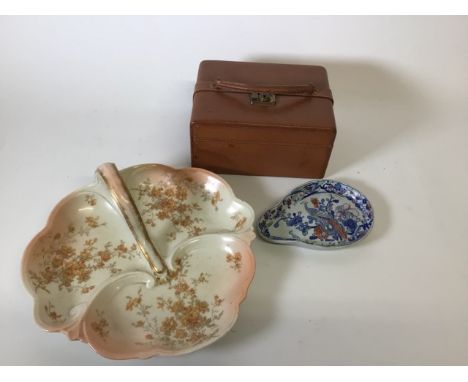 A collection of two ceramic items : a blue and white ironstone tear shaped dish with a french serving dish with handle and a 