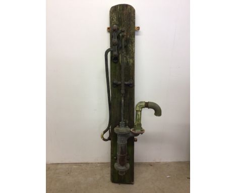 A vintage water pump mounted on wooden plinth W:45cm x D:20cm x H:164cm