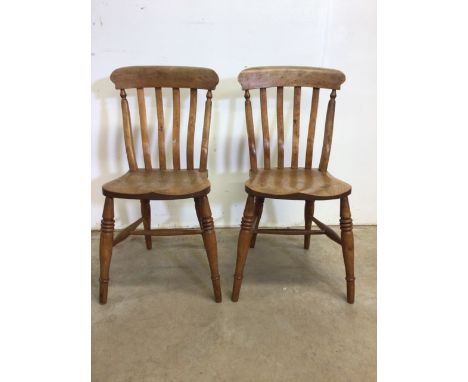 A pair of elm seated stick back country chairs