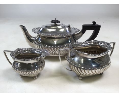 A Victorian sterling Silver three piece bachelors tea set with half fluted decoration by William Hutton &amp; Sons Ltd, Londo