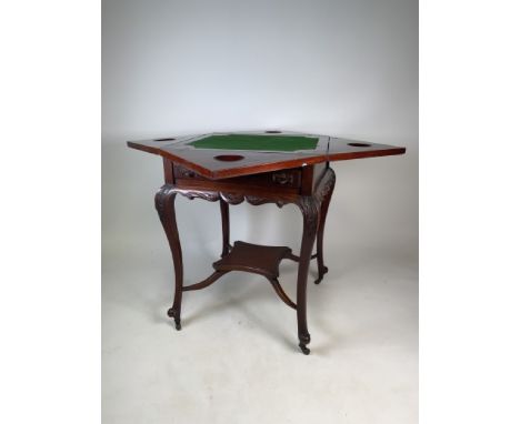 A Victorian mahogany four legged folding card table with lower shelf and single drawer. Quadrant card table with felt top on 