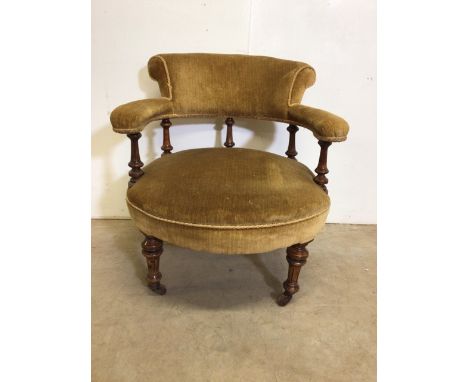 A Victorian upholstered nursing chair with turned legs and ceramic castors. W:63cm x D:63cm x H:69cm