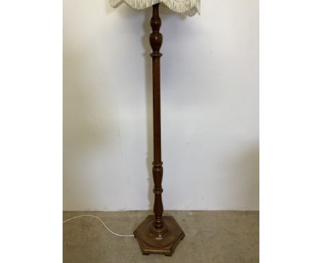A turned oak standard lamp with hexagon base.Without shade H:157cm