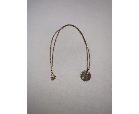 An 18 ct gold chain link necklace together with a 9 ct gold engine turned pendant. 7g.