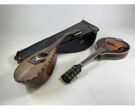 Two mandolins; one by Stridente in Napoli and the other Marque. Stridente mandolin has a shell and mother of pearl inlaid but