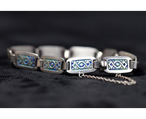 A Scottish silver panel bracelet with blue green enamel knot work decoration. 16.5g.