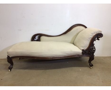 A Victorian chaise long with ornately carved detail, on ceramic casters. With traditional horsehair paddingSofa: W:193cm x D: