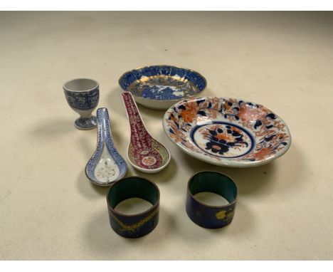 A collection of oriental style ceramic and cloisonne items. To include two rice spoons, two dishes an egg cup and a pair of n