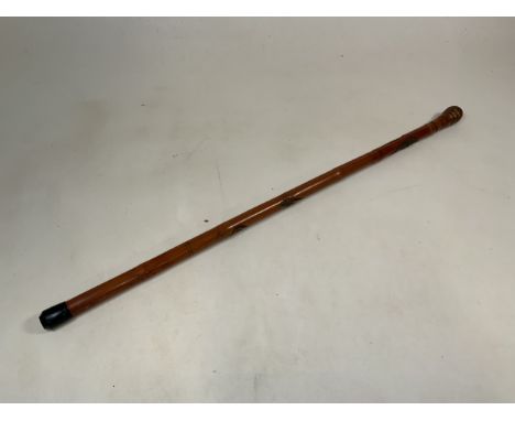 An Oriental style carved bamboo walking stick. Decorated with a snake wrapped around the cane and a Oriental lady. H:91cm