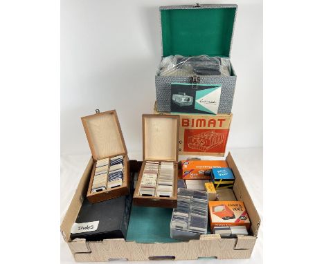 A vintage boxed Cabimat automatic slide projector together with a large collection of photographic slides. Slides to include 