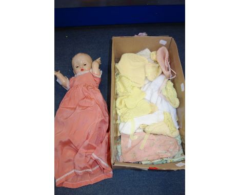 A VINTAGE PLASTIC DOLL with a collection of clothing