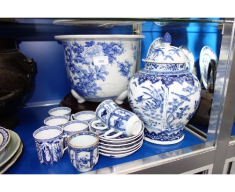 AN ORIENTAL BLUE AND WHITE JARDINIERE,  a similar vase (damaged) and a collection of blue and white cups and saucers