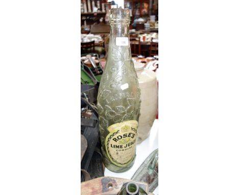 A LARGE VINTAGE GLASS DISPLAY BOTTLE OF "ROSE'S LIME CORDIAL", 59 cm high