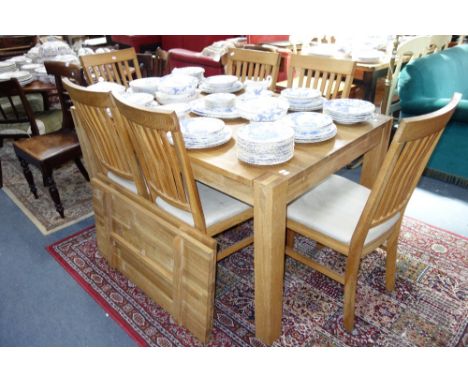 A CONTEMPORARY SOLID LIGHT OAK DINING SUITE, comprising six splat back dining chairs with suede effect seats and extending di