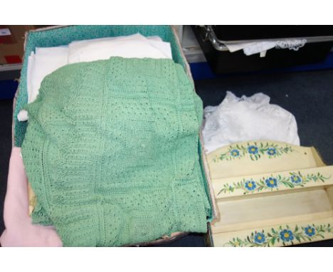 A VINTAGE TABLECLOTH with a crochet edge and similar textiles