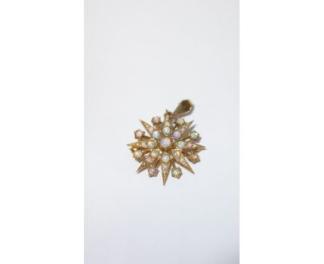 A 9CT YELLOW GOLD OPAL SET STAR BROOCH