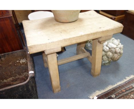 A LARGE VINTAGE "BUTCHER'S BLOCK" on heavy square legs, with a nicely 'worn-down' top, 98 cm wide x 59 cm deep x 76 cm high