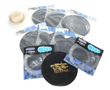 Selection of drum accessories including cymbal and stick bags. practice pads and two bongo heads