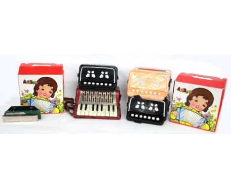 Old Hohner piccolo/child's accordion, with eight bass buttons, red marble finish; also two contemporary cased accordions and 