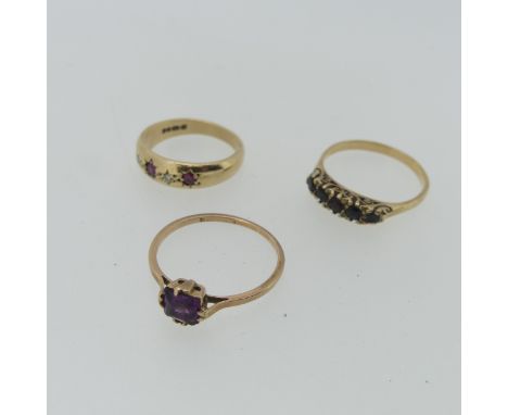 A 9ct yellow gold Band, gypsy set with three rubies and two small diamonds, Size M, together with a small five stone garnet r