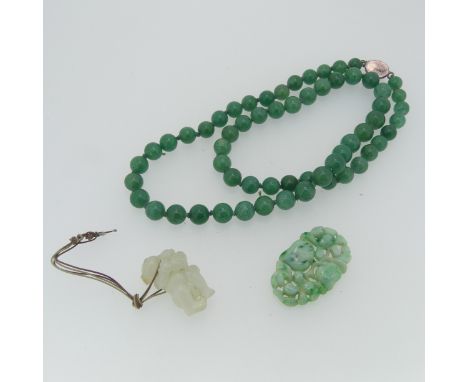 A jade circular bead Necklace, largest 10.3mm, smallest 8.2mm, on silver clasp, 62cm long, together with a quantity of carved