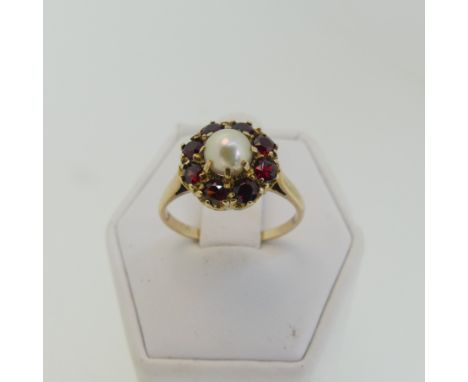 A cultured pearl and garnet Cluster Ring, cluster diameter 11.5mm, mounted in 9ct yellow gold, Size M½, total weight 2.7g. 