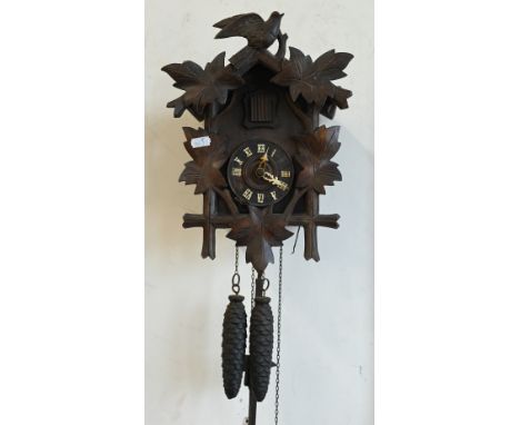 A traditional Continental Black Forest style cuckoo clock c/w pendulum and two pine cone weights, a/f 