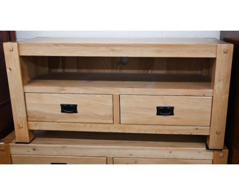 A modern light oak media unit with open shelf over two drawers with bronzed metal handles 120 cm wide x 46 cm deep x 58 cm hi