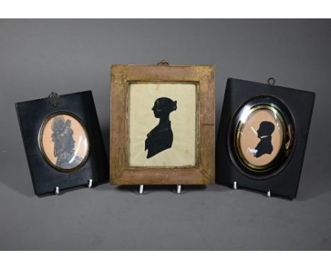 An antique ink and wash silhouette portrait of a lady in extravagant lace cap and collar, dated 1783 on reverse, in frame, to