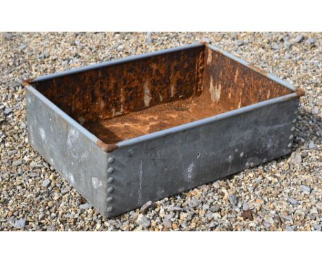A galvanised rivetted trough 