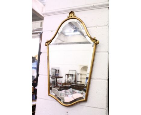 A gilt framed shield shaped mirror.