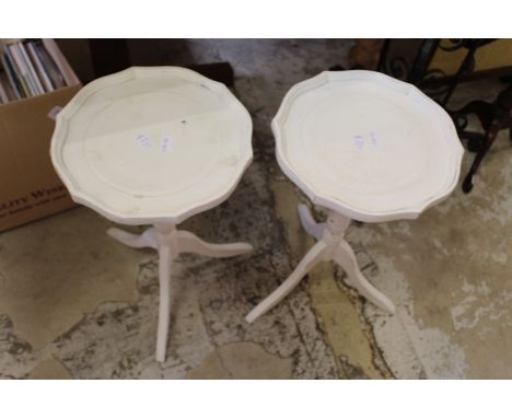 A pair of white painted tripod tables.