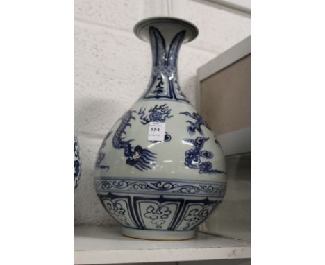 A large Chinese blue and white vase decorated with dragons chasing the pearl of wisdom.
