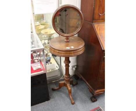 A Victorian style mahogany tripod wash stand with circular mirror.