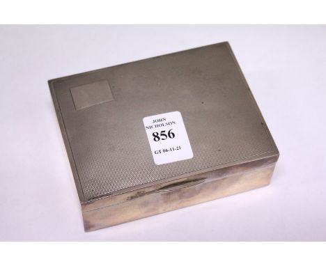 An engine turned silver cigarette box.