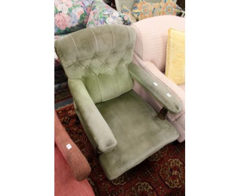 A Victorian button upholstered open armchair.