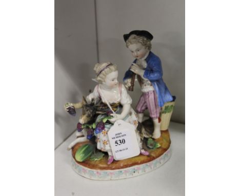 A continental porcelain group of two children, one playing a musical instrument, one feeding grapes to a goat.