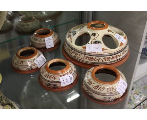 Mary Wondrausch for The Compton Pottery, an unusual terracotta and glazed egg holder with four matching egg cups.