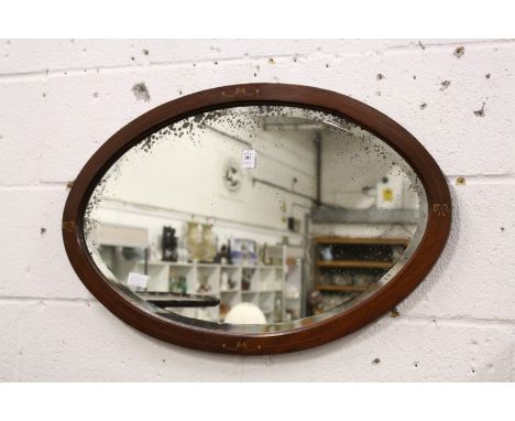 An oval wall mirror.