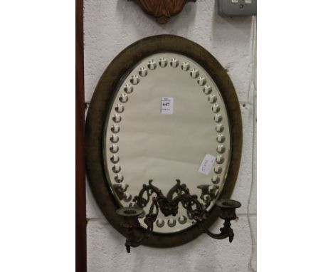 An oval mirror backed girandole.