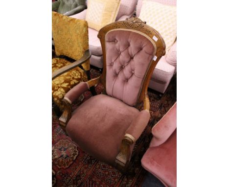 A Victorian beech framed button upholstered open armchair.