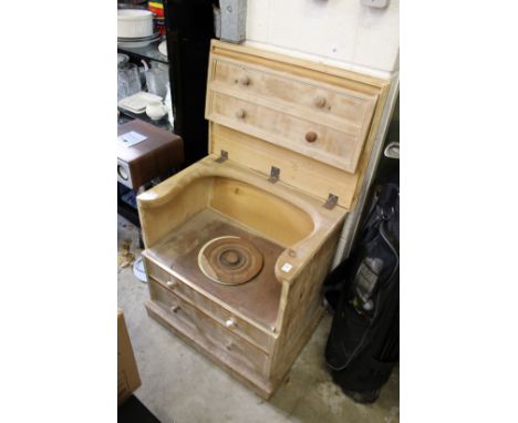 An old commode with lifting lid and original liner.